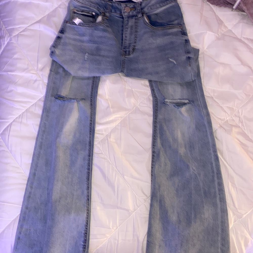 flare jeans with two knee rips light colored
